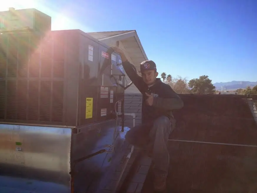 HVAC technician performing Air Duct Repair on a rooftop unit in Port Wentworth